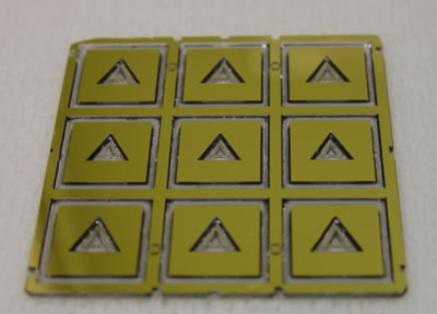 A quartz wafer comprising 9 resonators machined collectively by chemical etching.